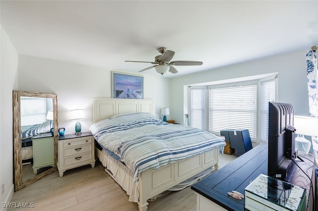 12130 Kelly Greens Blvd Unit 91, Fort Myers, FL 33908 - bedroom with light wood finished floors and ceiling fan