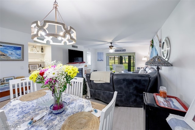 12130 Kelly Greens Blvd Unit 91, Fort Myers, FL 33908 - dining room with ceiling fan with notable chandelier and visible vents