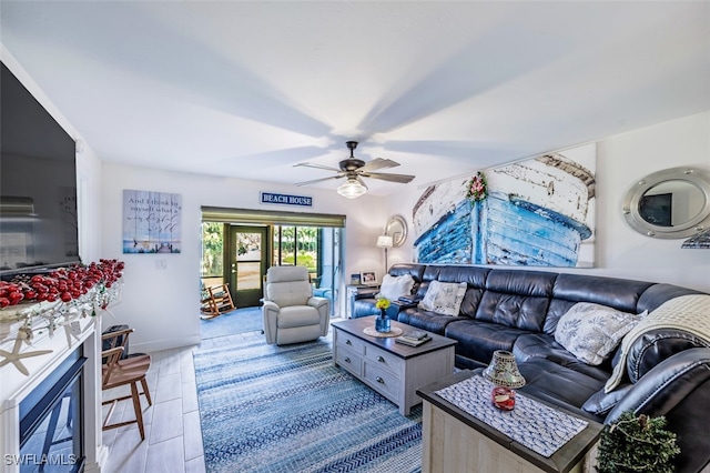 12130 Kelly Greens Blvd Unit 91, Fort Myers, FL 33908 - living room featuring baseboards and ceiling fan