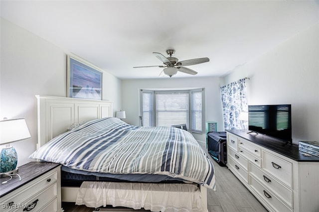 12130 Kelly Greens Blvd Unit 91, Fort Myers, FL 33908 - bedroom featuring light wood finished floors and ceiling fan