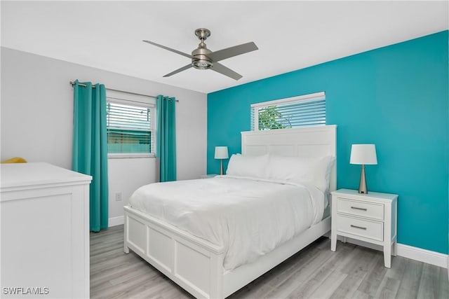 7666 Laurel Valley Rd, Fort Myers, FL 33967 - bedroom featuring light wood-style floors, baseboards, multiple windows, and a ceiling fan