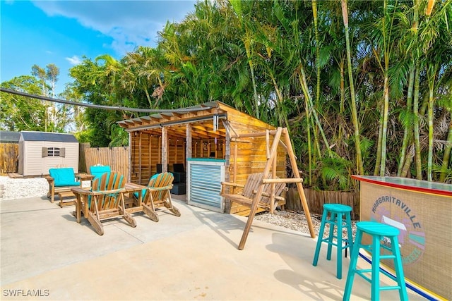 7666 Laurel Valley Rd, Fort Myers, FL 33967 - view of patio / terrace with a storage unit, an outdoor structure, and fence