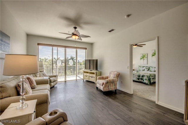 living room featuring baseboards, dark wood-style flooring, visible vents, and ceiling fan
