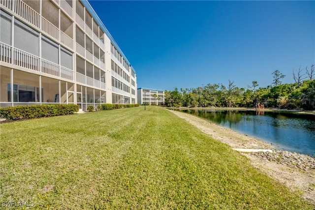 view of community with a water view and a lawn