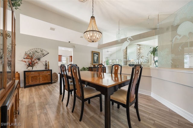 dining area featuring an inviting chandelier, light wood-style flooring, baseboards, and visible vents