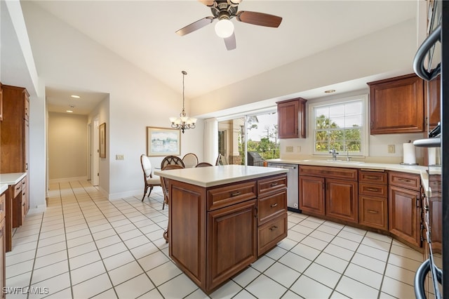 kitchen with stainless steel dishwasher, lofted ceiling, light tile patterned flooring, light countertops, and a sink