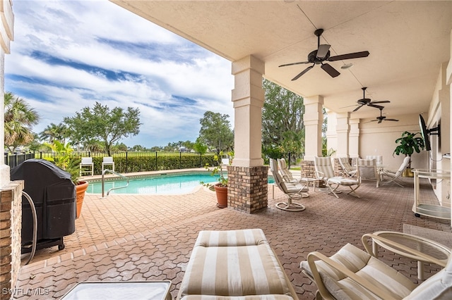 view of swimming pool with a fenced in pool, fence, a patio, and a ceiling fan