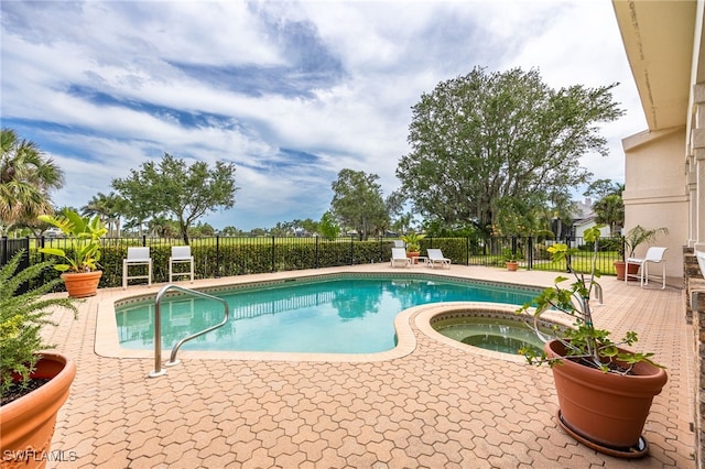 view of pool featuring fence, an in ground hot tub, and a fenced in pool
