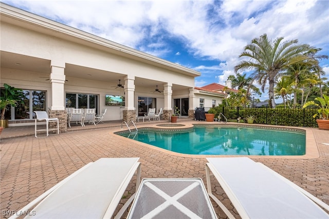 view of swimming pool featuring a fenced backyard, a ceiling fan, a fenced in pool, and a patio area