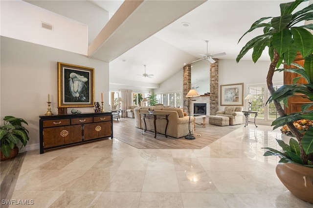 living room featuring high vaulted ceiling, visible vents, a ceiling fan, and a wealth of natural light
