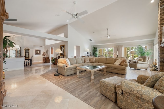 living room featuring high vaulted ceiling, baseboards, and a ceiling fan