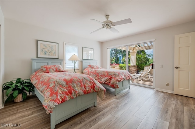 bedroom featuring access to outside, baseboards, ceiling fan, and wood finished floors