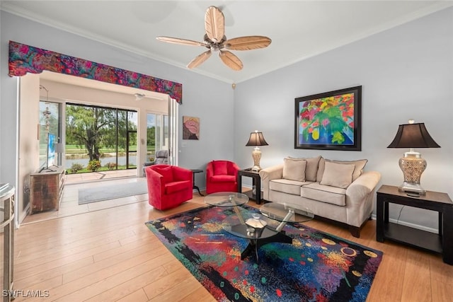 living area with crown molding, ceiling fan, and wood finished floors