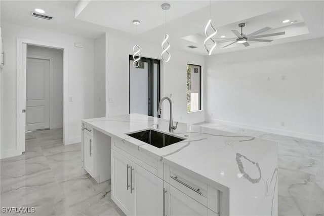 3518 50th St W, Lehigh Acres, FL 33971 - kitchen featuring ceiling fan, light stone countertops, a sink, marble finish floor, and white cabinetry