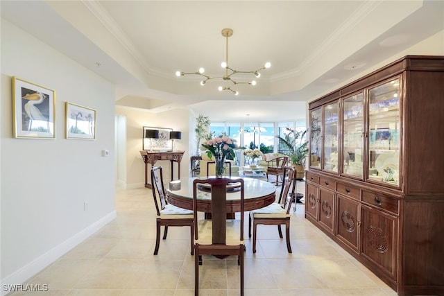 1050 Borghese Ln Unit 206, Naples, FL 34114 - dining room with a chandelier, a raised ceiling, crown molding, baseboards, and light tile patterned floors