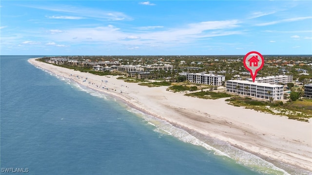 drone / aerial view featuring a view of the beach and a water view