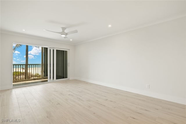 spare room featuring ornamental molding, light wood-style flooring, and a ceiling fan
