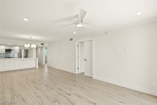 unfurnished living room with baseboards, light wood-style flooring, recessed lighting, and ceiling fan with notable chandelier