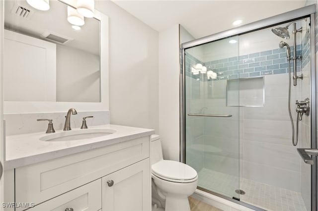 bathroom featuring toilet, visible vents, and a shower stall