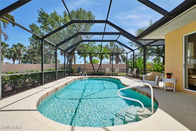 16168 Cutters Ct, Fort Myers, FL 33908 - view of swimming pool featuring a fenced in pool, glass enclosure, a patio area, and fence