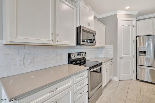 kitchen with crown molding, tasteful backsplash, light stone counters, stainless steel appliances, and white cabinetry