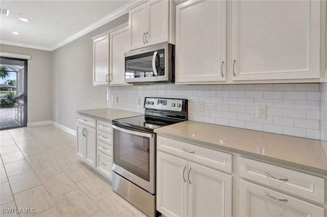 kitchen with crown molding, baseboards, backsplash, and stainless steel appliances