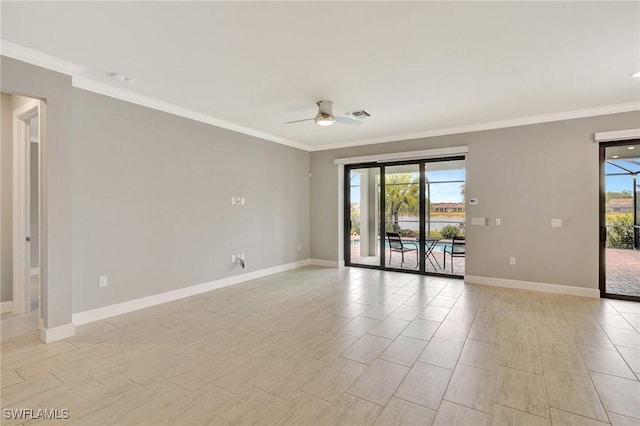 spare room featuring baseboards, ornamental molding, a ceiling fan, and visible vents