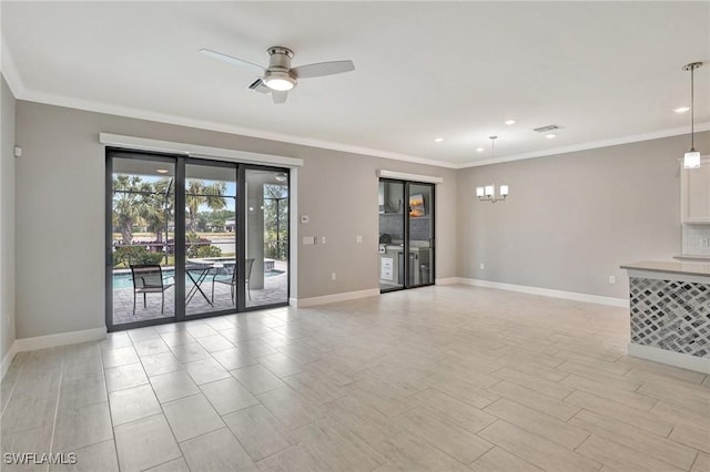 unfurnished living room featuring baseboards, crown molding, ceiling fan with notable chandelier, and recessed lighting