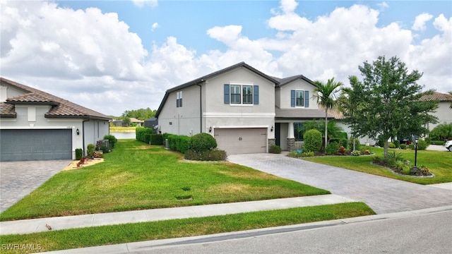 view of front facade with decorative driveway, a front lawn, and stucco siding