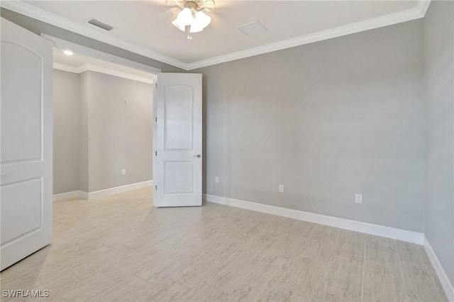 unfurnished room with ceiling fan, light wood finished floors, baseboards, visible vents, and ornamental molding