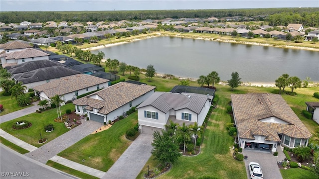 birds eye view of property featuring a water view and a residential view