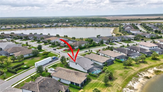 drone / aerial view with a water view and a residential view