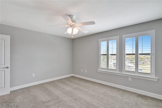 unfurnished room featuring baseboards, a ceiling fan, and carpet flooring