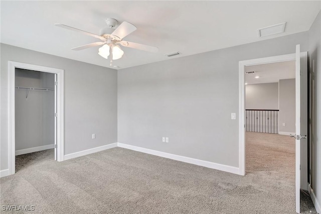 unfurnished bedroom featuring baseboards, carpet, a closet, and visible vents