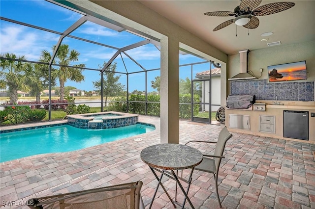 view of swimming pool with area for grilling, ceiling fan, exterior kitchen, a patio area, and a sink