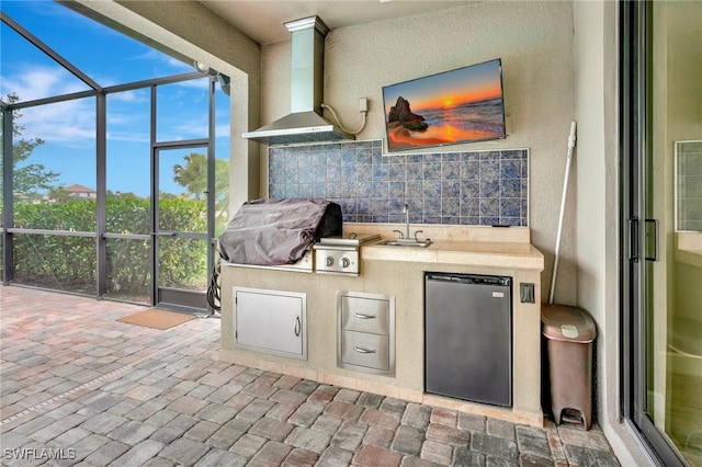 interior space featuring a sink, exterior kitchen, and grilling area