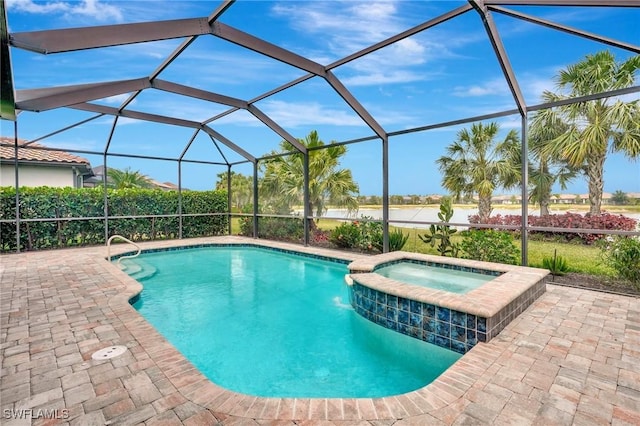 view of swimming pool with a patio, a pool with connected hot tub, and a lanai