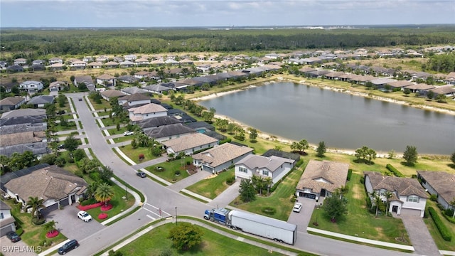 birds eye view of property with a water view and a residential view