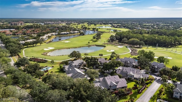 drone / aerial view featuring a water view, golf course view, and a residential view