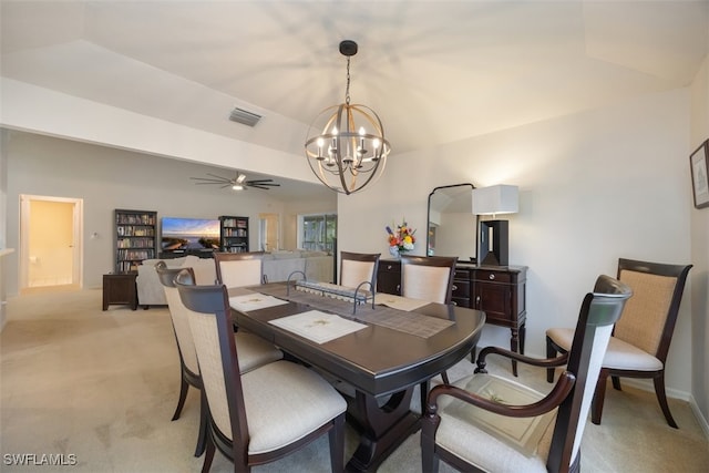 dining space with lofted ceiling, visible vents, light colored carpet, and ceiling fan with notable chandelier