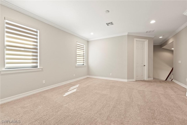 empty room with crown molding, visible vents, baseboards, recessed lighting, and light colored carpet