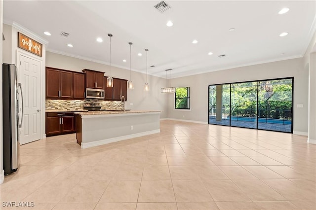 kitchen featuring appliances with stainless steel finishes, a sink, recessed lighting, open floor plan, and visible vents