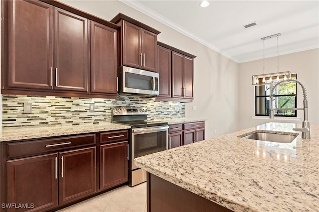 kitchen featuring visible vents, tasteful backsplash, light stone countertops, a sink, and stainless steel appliances