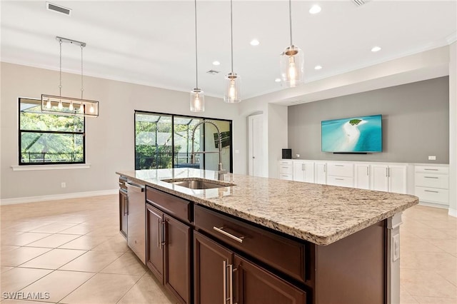 kitchen with visible vents, stainless steel dishwasher, a center island with sink, baseboards, and light tile patterned flooring