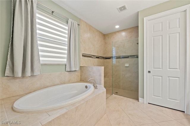 full bathroom featuring a garden tub, visible vents, tile patterned floors, recessed lighting, and tiled shower