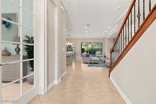 14351 Tuscany Pointe Trl, Naples, FL 34120 - corridor featuring a chandelier, ornamental molding, baseboards, and tile patterned flooring