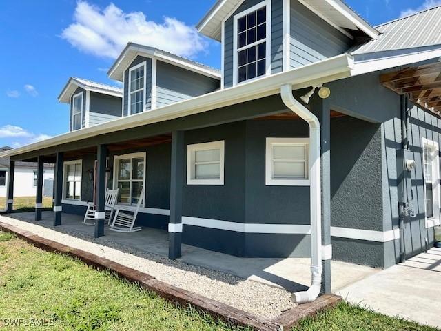 7834 15th Pl, Labelle, FL 33935 - view of home's exterior featuring covered porch