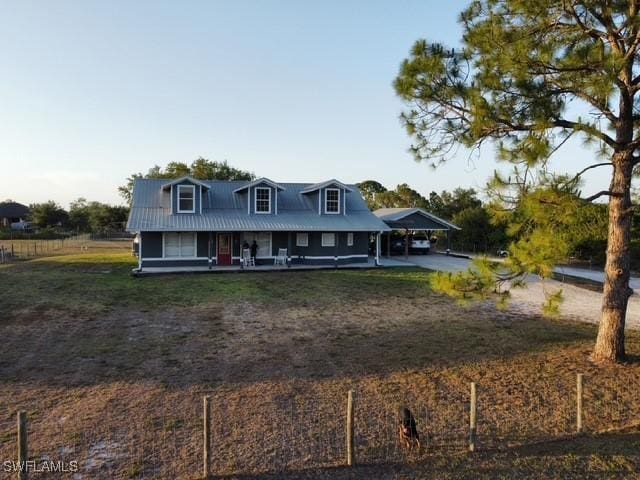 7834 15th Pl, Labelle, FL 33935 - farmhouse-style home featuring a carport, a porch, and a front lawn