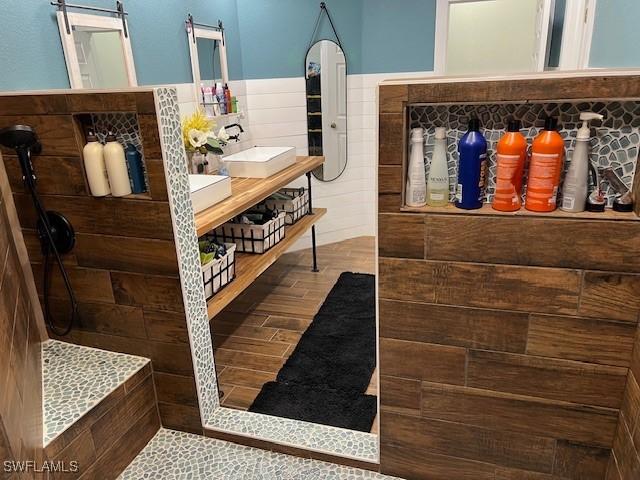 7834 15th Pl, Labelle, FL 33935 - full bathroom featuring double vanity, a walk in shower, tile walls, and a sink