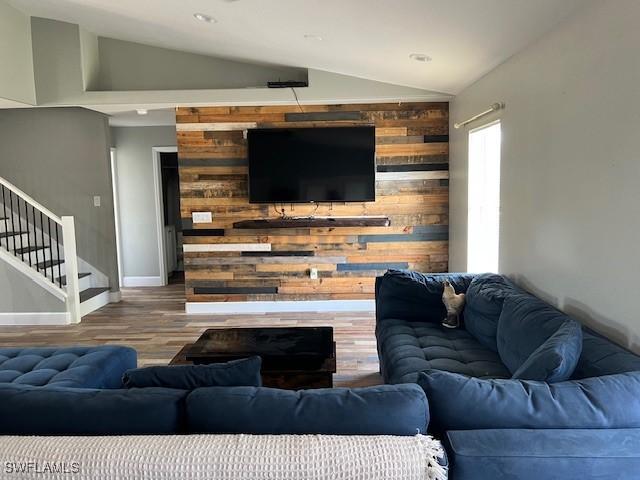 7834 15th Pl, Labelle, FL 33935 - living area featuring baseboards, vaulted ceiling, wood finished floors, and stairway